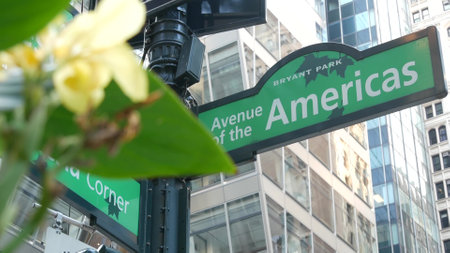 New York City crossroad, street intersection green road sign. 6 Sixth ave, Americas avenue corner, Midtown business district, United States. Highrise skyscraper architecture, Bryant park text roadsignの写真素材