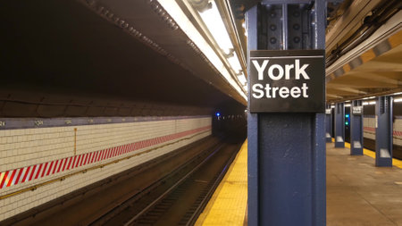 New York City empty subway station interior, underground metropolitan platform sign. Metro railway passenger public transport, United States. Perspective. Text signboard York Street. Brooklyn Downtownの写真素材