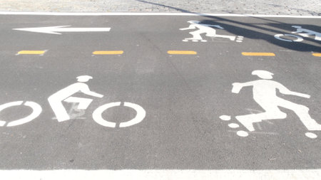 Bike lane asphalt sign, New York City. Bicycle path, cycle route for bicyclists, Manhattan. Recreational sport activity infrastructure, biker cycling, United States.の写真素材