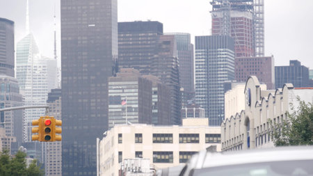 New York City street crossroad, yellow traffic light, transport road intersection, United States. Building architecture. Queens, Long Island. Manhattan cityscape, Midtown skyline, highrise skyscrapersの写真素材