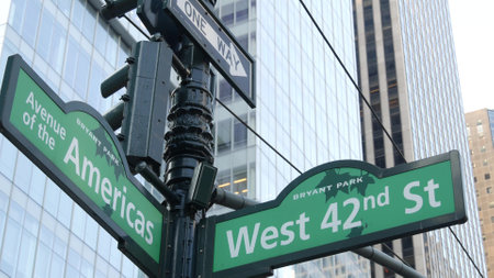 New York City crossroad, 42 street intersection road sign. 6 Sixth ave, Americas avenue corner, Midtown business district, NYC, Bryant park. Highrise skyscraper architecture, one way text roadsign.の写真素材