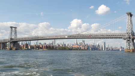 New York City skyline from ferry boat. Manhattan midtown highrise skyscrapers view from ferryboat. East river waterfront panorama, riverfront buildings architecture near water USA. Williamsburg Bridgeの写真素材