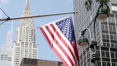 New York, american flag waving. Chrysler building. Manhattan midtown 42 street, city architecture. Symbol of freedom, democracy, liberty and patriotism. Star-Spangled Banner, Old Glory. Stars, Stripesの写真素材