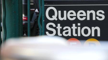 New York subway sign, Queens underground metro station. Metropolitan entrance fence, public transport exit. Long Island city street, NYC United States. Navigation text on signboard. Passenger guidanceの写真素材