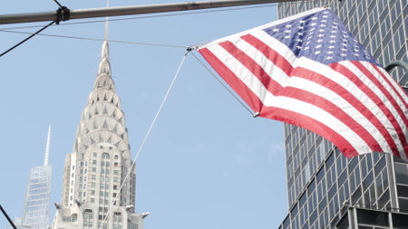 New York, american flag waving. Chrysler building. Manhattan midtown 42 street, city architecture. Symbol of freedom, democracy, liberty and patriotism. Star-Spangled Banner, Old Glory. Stars, Stripesの写真素材