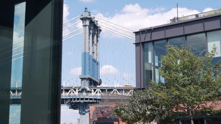 New York City Manhattan Bridge to Brooklyn Dumbo. View from waterfront market rooftop, United States travel destination. USA architecture, cable-stayed bridge. Tourist landmark. Cars on elevated road.の写真素材