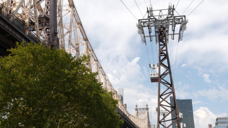 New York City Roosevelt Island tramway to Manhattan Midtown. American aerial cable tram near Queensboro Bridge. Urban public passenger transport, USA. Transportation and architecture in United States.の写真素材