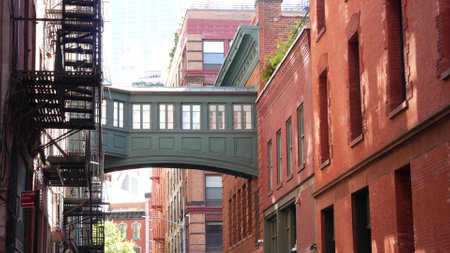 New York City Staple street skybridge. Vintage retro industrial architecture, red brick building. American old historic cooper elevated sky bridge Manhattan landmark, USA. Fire escape ladder.の写真素材