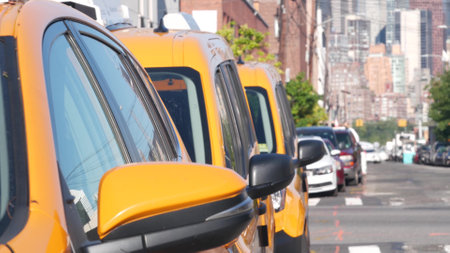 New York City. Row of yellow Taxi cars on street, Queens. Many taxi cabs on avenue, Long Island,...