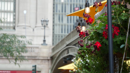 New York City Grand Central Terminal railway station, 42 street. Manhattan Midtown. Bridge on Pershing Square, NYC, USA. American urban scene, United States. Light bulb garland, umbrellas and flowers.の写真素材