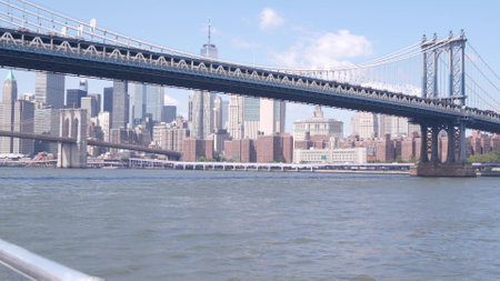 New York City downtown skyline from ferry boat. Manhattan and Brooklyn bridge. World Trade Center...