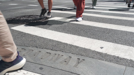Broadway street sign, people on pedestrian zebra crossroad. New York City Manhattan road...