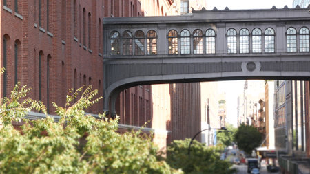 New York City street, Chelsea Market skybridge. Retro industrial architecture, red brick building. American old historic elevated sky bridge Manhattan landmark, USA. Meatpacking district, High Line.の写真素材