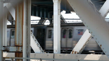 New York City Manhattan Bridge to Brooklyn Dumbo. American subway metro train from pedestrian path....