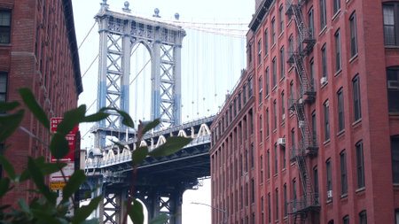 New York City Manhattan Bridge in Dumbo, Brooklyn. Red brick building on Washington street near...