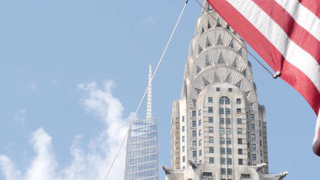 New York, american flag waving. Chrysler building. Manhattan midtown 42 street, city architecture. Symbol of freedom, democracy, liberty and patriotism. Star-Spangled Banner, Old Glory. Stars, Stripesの写真素材