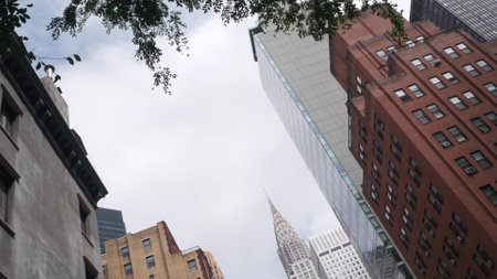 New York City Manhattan Midtown 42 street architecture. Chrysler building, iconic high-rise skyscraper, Lex Lexington avenue, USA. American urban residential red brick house, NYC tower, United States.の写真素材