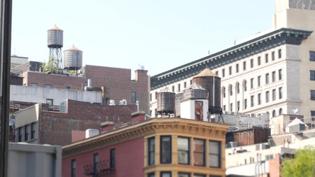 New York City Broadway, Manhattan midtown Union Square building architecture. Urban residential house exterior. Real estate property in USA. Typical brick facade. Rooftop water tower, tank on roof.の写真素材
