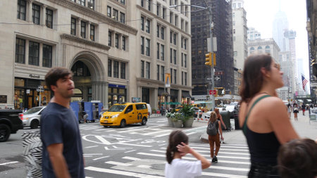 New York City, United States - 8 Sept 2023: Manhattan Midtown street, 5th, Fifth 5 avenue. American urban road car traffic, people. Yellow taxi cab in USA. Empire State building and people pedestriansのeditorial素材