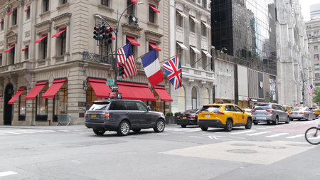New York City, United States - 13 Sept 2023: Manhattan Midtown street, Fifth 5 avenue. American urban road car traffic. Yellow taxi cab in USA. People. Boutique fashion stores for shopping. Cartier.のeditorial素材