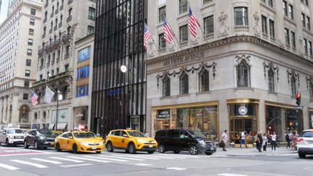 New York City, United States - 11 Sept 2023: Manhattan Midtown street, Fifth 5 avenue. American urban road car traffic, crossroad intersection. Yellow taxi cab in USA. People pedestrians go shopping.のeditorial素材