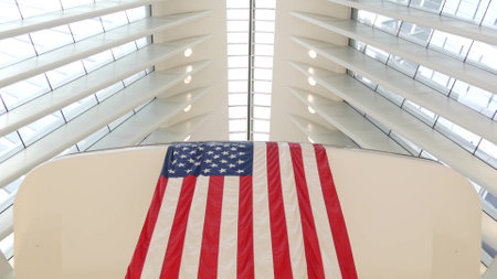 New York City, United States - 10 Sept 2023: World Trade Center Oculus architecture. Manhattan Downtown Financial District, USA. September 11 remembrance, large memorial american flag. 911 Patriot dayのeditorial素材