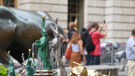 New York City, United States - 9 Sept 2023: Charging Bull, Wall street Stock Exchange symbol in USA. Lower Manhattan Downtown Financial District. American Broadway street. Tourist people photographingのeditorial素材