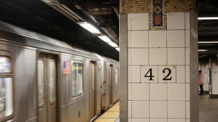 New York City, United States - 29 Aug 2023: Subway station interior, underground metropolitan platform sign. Metro railway train, passenger transport. Text 42 street. Grand Central Terminal, Manhattanのeditorial素材
