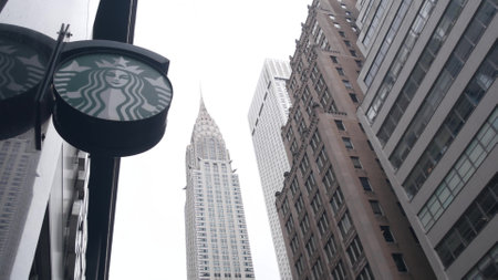 New York City, United States - 29 Aug 2023: Manhattan Midtown street, Lexington Lex avenue. Urban architecture in USA. Starbucks coffee logo, Chrysler building. High-rise skyscraper tower. NYC symbol.のeditorial素材