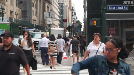 New York City, United States - 29 Aug 2023: Manhattan Midtown East 42 street, Lexington Lex avenue crossroad intersection. Urban road car traffic in USA. People, pedestrians on zebra. Amazon go store.のeditorial素材
