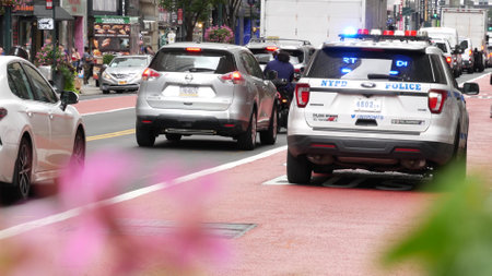 New York City, United States - 29 Aug 2023: Police patrol car, USA NYPD, 911 vehicle on Manhattan Midtown 34th street. American cop auto siren on avenue, urban traffic scene, Herald square in NYC.のeditorial素材