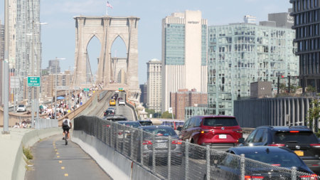New York City, United States - 3 Sept 2023: Cars on Brooklyn Bridge from Manhattan downtown to Dumbo. Financial district skyline cityscape. Road traffic, people walking and USA architecture.のeditorial素材