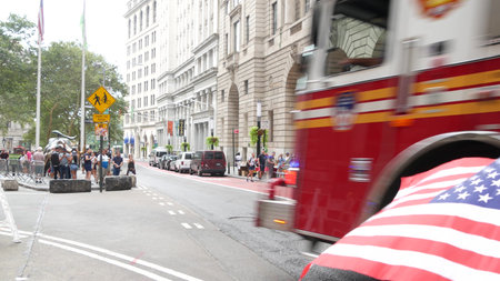 New York City, United States - 9 Sept 2023: NYFD car, USA fire department truck, american firefighters vehicle or fire fighter engine, Broadway, Manhattan Downtown financial district. Charging Bull.のeditorial素材