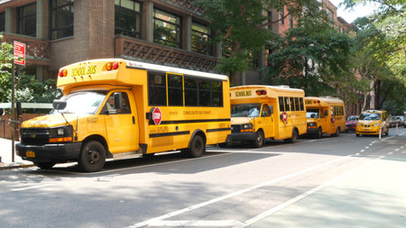New York City, United States - 8 Sept 2023: Row of yellow school bus truck, Manhattan street road....