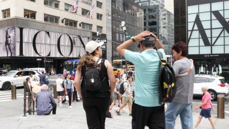 New York City, United States - 11 Sept 2023: Manhattan Midtown street, Fifth 5 avenue. American urban road car traffic, crossroad intersection. Yellow taxi in USA. People pedestrians. Shopping stores.のeditorial素材