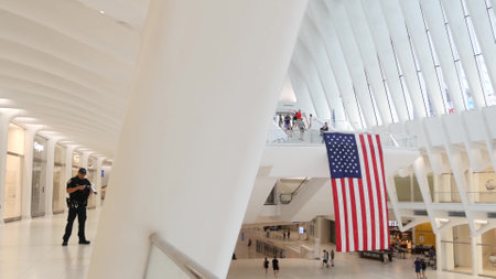 New York City, United States - 10 Sept 2023: World Trade Center Oculus building. Manhattan Downtown Financial District, USA urban life. People. September 11 remembrance american flag. Police officer.のeditorial素材