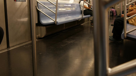 New York City, United States - 29 August 2023: Subway train, people inside metropolitan wagon. Metro transport, passenger transportation, public underground railway. Railroad traffic. Cabin interior.のeditorial素材