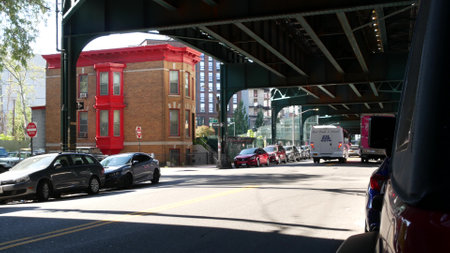 New York City, United States - 31 Aug 2023: Elevated subway above street. Metropolitan bridge over road, Queens. Long Island metro line, Court Square. Cars under metallic railway track. NYC urban lifeのeditorial素材