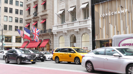 New York City, United States - 13 Sept 2023: Manhattan Midtown street, Fifth 5 avenue. American urban road car traffic. Yellow taxi cab in USA. People. Boutique fashion stores for shopping. Cartier.のeditorial素材