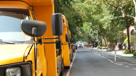 New York City, United States - 8 Sept 2023: Row of yellow school bus truck, Manhattan street road....