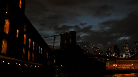 New York City, United States - 11 Sept 2023: Brooklyn Bridge, Manhattan downtown skyline cityscape. Waterfront Pebble Beach, carousel in Dumbo USA. Dramatic twilight dusk. Evening sky, Time Out Marketのeditorial素材