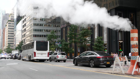 New York City, United States - 11 Sept 2023: Manhattan Midtown street, 5 Fifth 5th avenue. American urban road car traffic. Rolex store, fashion shopping boutique in USA. Hot smoke stack, steam pipe.のeditorial素材