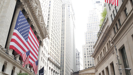 New York City, United States - 9 Sept 2023: Lower Manhattan Downtown Financial District urban architecture. Huge big American flag. Wall street Stock Exchange building, USA Stock Market trading.のeditorial素材