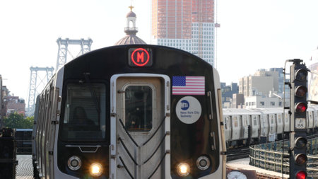 New York City, United States - 7 Sept 2023: Subway station. Metro train, public transportation platform. Elevated outdoor NYC railway Marcy Av, Brooklyn passenger railroad traffic, Williamsburg Bridgeのeditorial素材