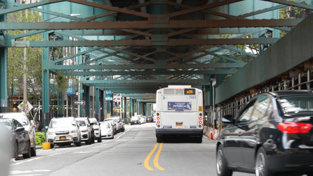 New York City, United States - 31 Aug 2023: Elevated subway above street. Metropolitan bridge over...