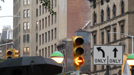 New York City, United States - 8 Sep 2023: Subway entrance globe, orb lamp. Yellow traffic light, Manhattan Midtown road intersection, street crossroad sign. Metropolitan underground metro transport.のeditorial素材