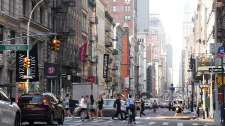 New York City, United States - 8 Sept 2023: Manhattan Soho District, Broadway street perspective. Urban road car traffic, yellow taxi, people. USA building architecture, Fashion stores for shopping.のeditorial素材