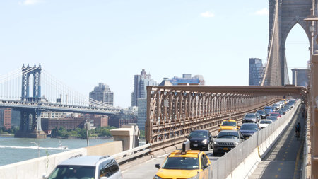New York City, United States - 3 Sept 2023: Cars on Brooklyn Bridge, Manhattan Bridge view. Yellow...