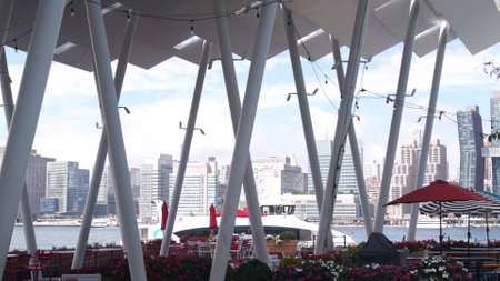 New York City, United States - 30 Aug 2023: Waterfront skyline, Manhattan Midtown buildings, riverfront skyscrapers by East river. Waterside cityscape, Hunters Point pier columns, Long Island, Queens.のeditorial素材