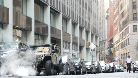 New York City, United States - 9 Sept 2023: Hot smoke from manhole, Con Edisons Steam system. Vapor from road, car on Beaver Street, NYC Downtown Financial District, Lower Manhattan, USA. Urban sceneのeditorial素材